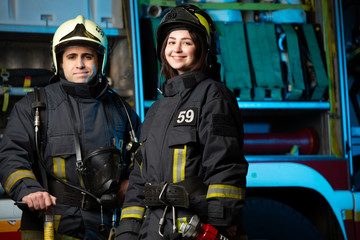 Photo of happy fireman and woman near fire truck