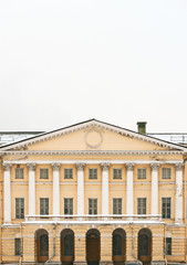 The facade of a historic building. Columns, capitals and high doors