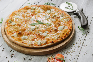 Pizza Formaggio with mozzarella, emental cheese, and cheese philadelphia on wooden background