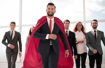businessman is a superhero, stepping ahead of his business team © ASDF