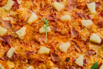 Tasty Hawaiian pizza with tomato sauce and pineapple on the white wooden background
