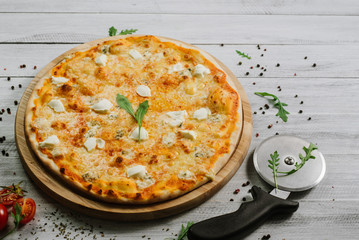 Pizza Formaggio with mozzarella, emental cheese, and cheese philadelphia on wooden background