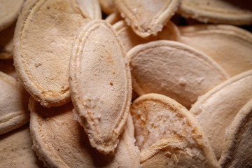 Roasted and salted pumpkin seeds. Close up, macro photos.