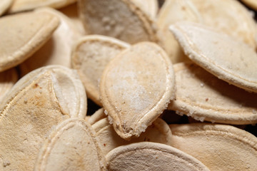 Roasted and salted pumpkin seeds. Close up, macro photos.