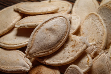 Roasted and salted pumpkin seeds. Close up, macro photos.