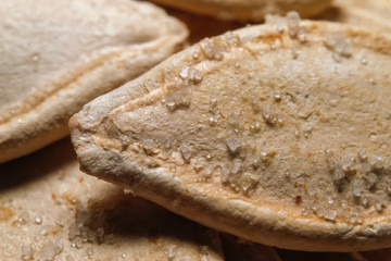 Roasted and salted pumpkin seeds. Close up, macro photos.