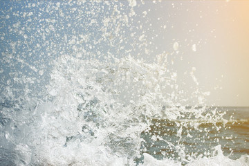 Splashes of sea waves in light of the sun. close-up