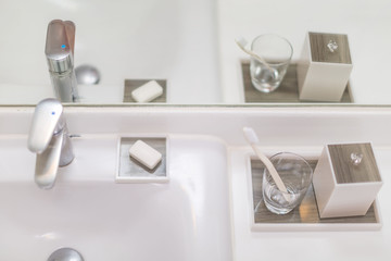 bright white Bathroom with shiny faucet soap dishes Toothbrush in tumbler sanitary box in elegance style