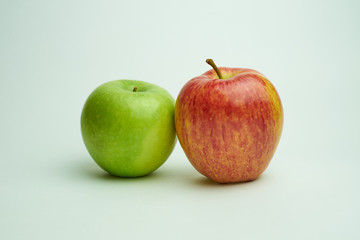 red and  green apple on white background