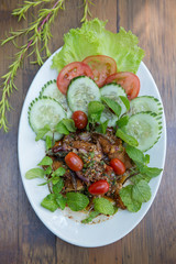 Spicy herbs salad with deep fried fish and vegetables vegetables Thai food