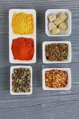 Set of Various spices on black stone table. Top view