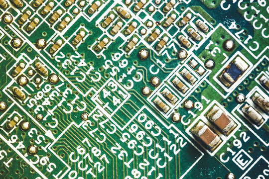 Green circuit board closeup macro electronics background.