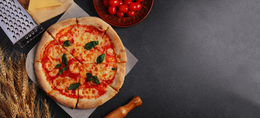 pizza banner. pizza margarita with ingredients top view on cement background