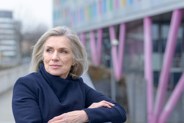 Thoughtful woman looking back over her shoulder