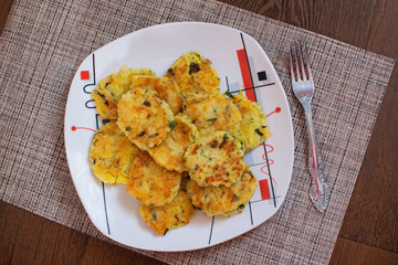 Potato pancakes with green onions. Draniki - potato fritters. The naitonal dish of Belarus, Ukraine and Russia. Potato zucchini cakes.