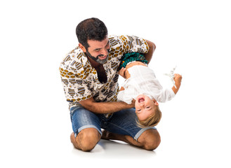 Adorable little baby with his father tickling on isolated white background