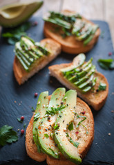 Close-up of fresh avocado toast with spices on dark background 