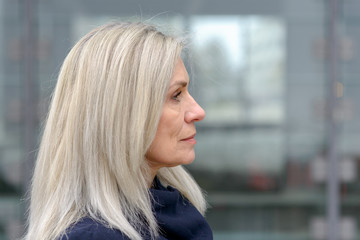 Right facing profile portrait of a mature woman