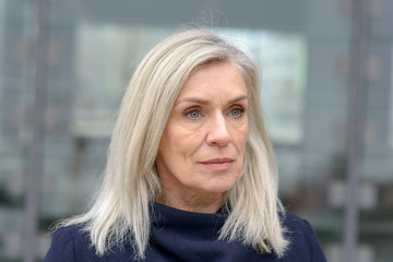 Pretty thoughtful blue eyed blond woman