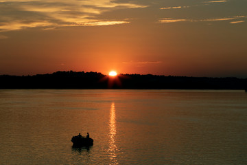 Days end with the setting sun overlooking fisherman.