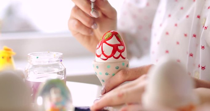 Girl and boy drawing Easter eggs, close up 4k Footage. White background , brother and sister. 