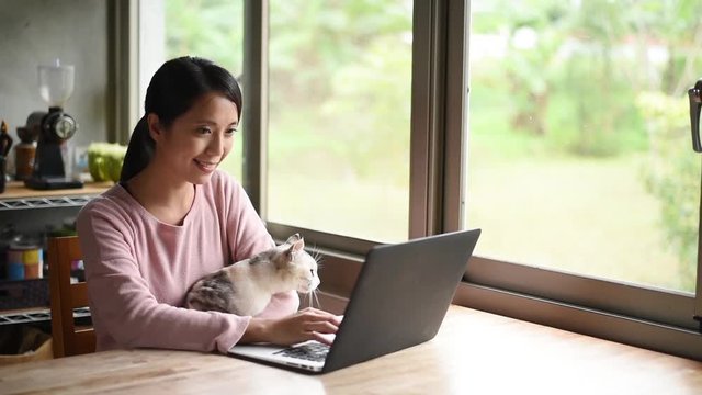 woman working at home with her cat