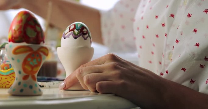 Girl and boy drawing Easter eggs, close up 4k Footage. White background , brother and sister. 