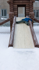 boy riding a wooden slide