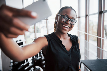 An American business woman speaks on her cellphone in the office.