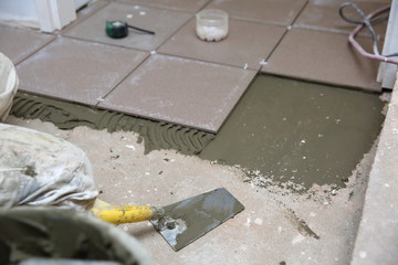 A plastic construction bucket with cement based glue ready to be used for gluing ceramic tiles.