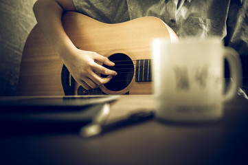 Musicians are playing guitar and singing songs that are composed. - Images