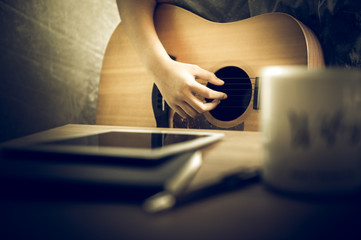 Musicians are playing guitar and singing songs that are composed. - Images
