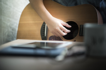 Musicians are playing guitar and singing songs that are composed. - Images