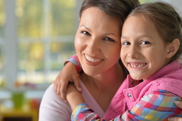 Portrait of charming little girl with mom