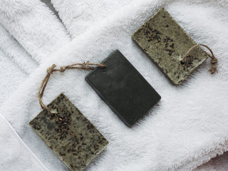 Natural handmade soap on a on white towel. Top view, close-up. Concept of beauty and body care