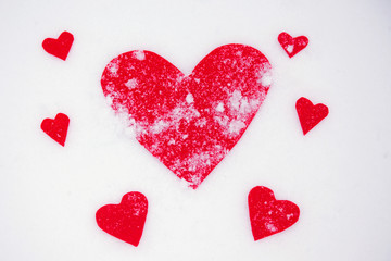 Red hearts on the snow white background