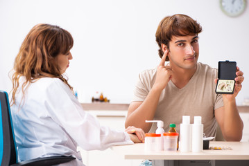 Obraz premium Patient with hearing problem visiting doctor otorhinolaryngologi