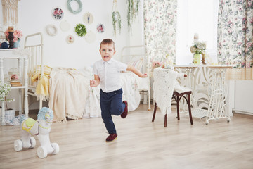 little boy running in the room. It's happy that my mother came to take home from the mothers' garden