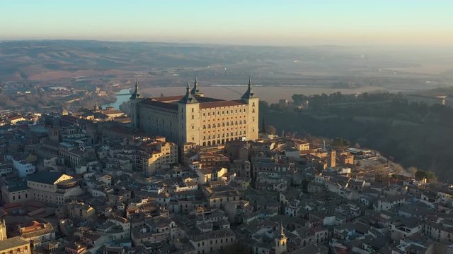 Aerial view of cityscape of Toledo at sunrise, historic center of city, castle Alcazar de Toledo - landscape panorama of Castilla&ndash;La Mancha from above, Spain, Europe