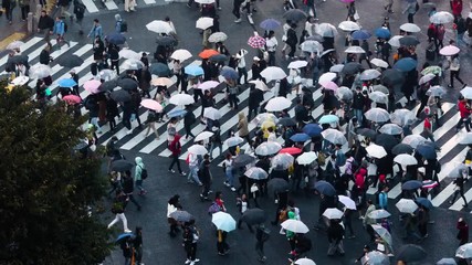 Thousands of people walk across the famous Shibuya Crossing in Tokyo Japan