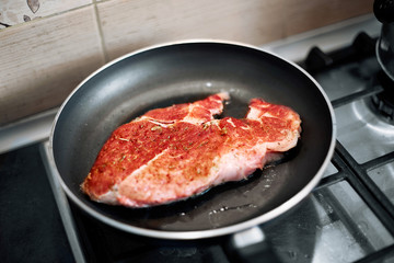 juicy grilled steaks in a frying pan