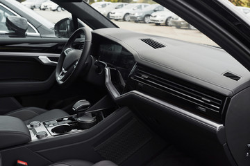 Fototapeta na wymiar Interior of a prestigious modern black car. Leather comfortable seats and accessories and steering wheel