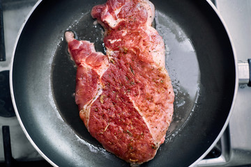 juicy grilled steaks in a frying pan
