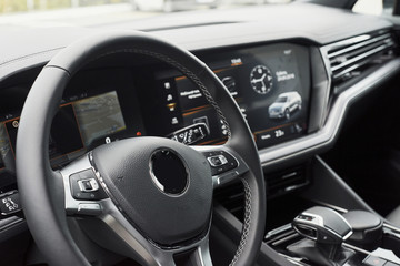 Interior of a prestigious modern black car. Leather comfortable seats and accessories and steering wheel