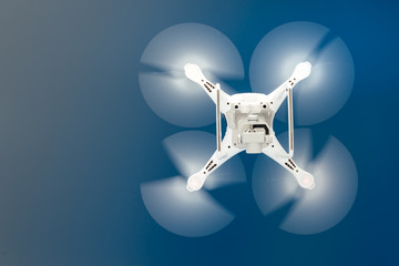 Close up details of uav drone copter flying in clear blue sky