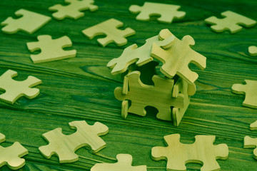 house of wooden puzzles on a wooden background. the logic, interactions, components.