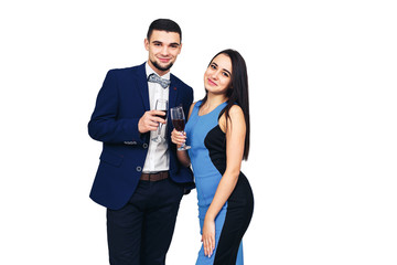 young happy stylish couple in blue clothes posing with glasses of wine