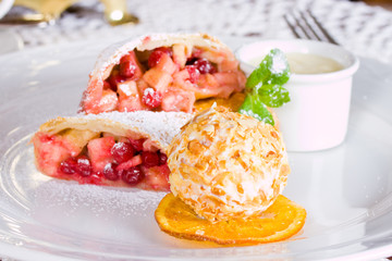 Apple strudel and ice cream ball with cashew nuts