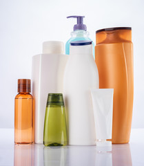 Shower products on white reflective background