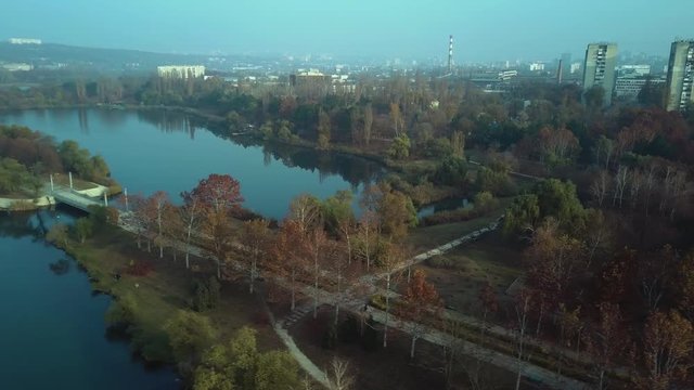 Aerial footage over Echo Park Lake, Kishinev, Moldova republic of. View of lake and smille bridge.